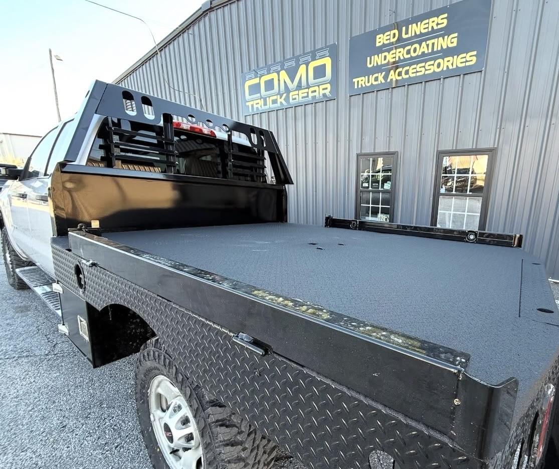 Concise / Short: Custom black flatbed truck body with headache rack and spray bed liner